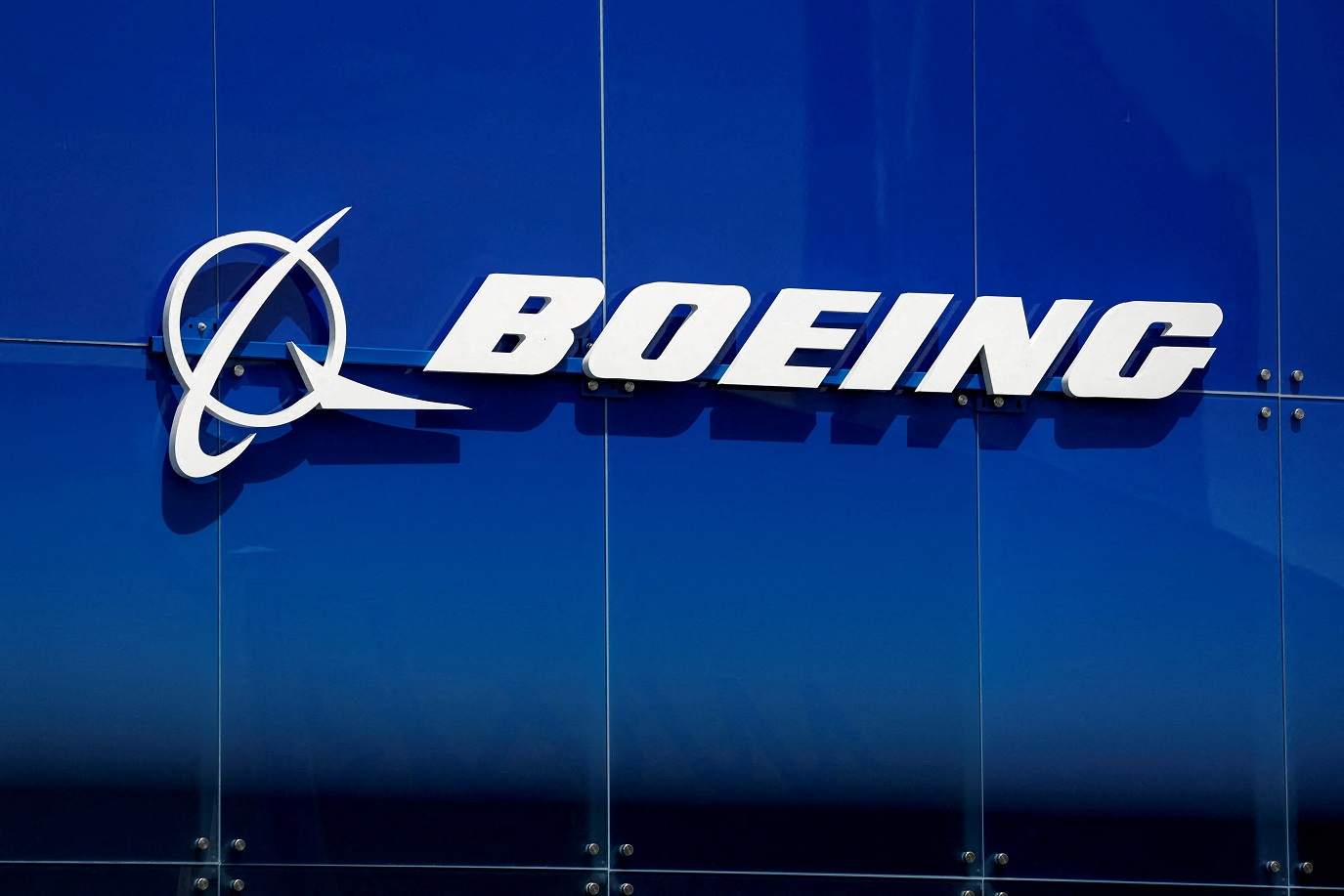 Emblema da empresa Boeing em fundo azul.