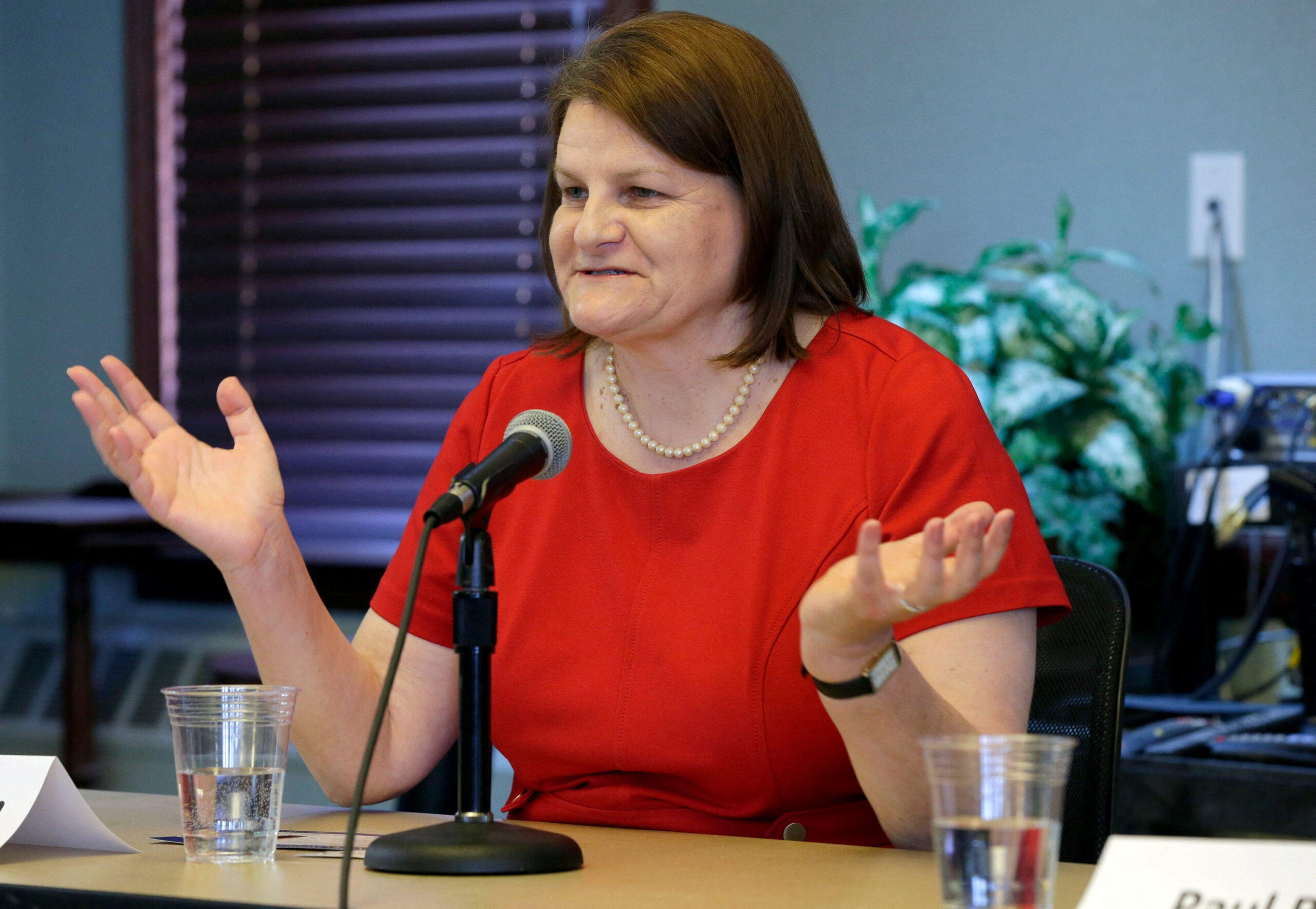 Hannah Dugan speaking at a forum.