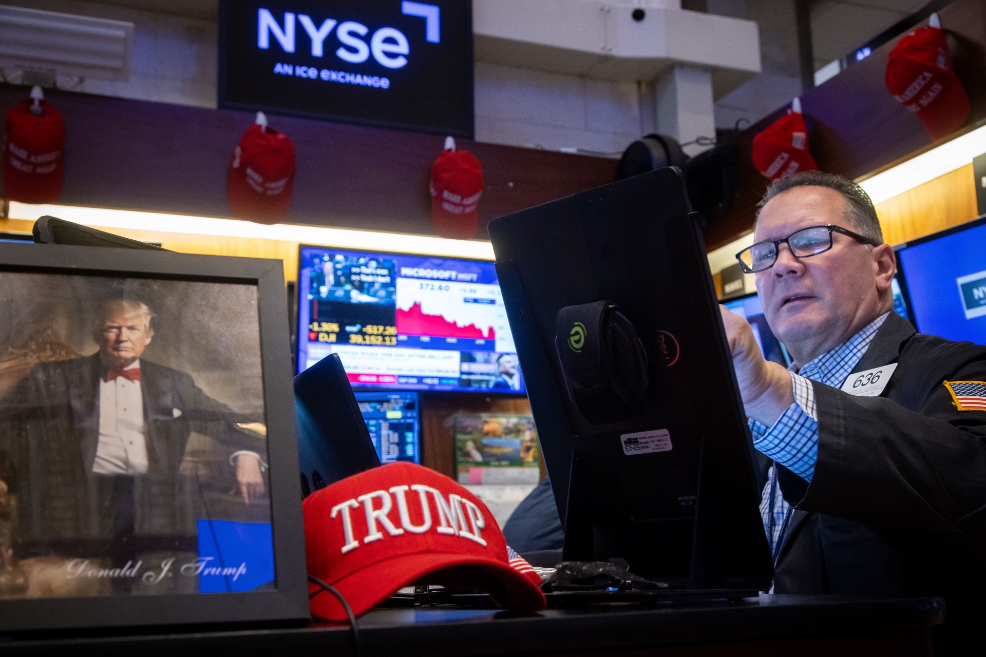 A trader working diligently on the stock exchange floor.