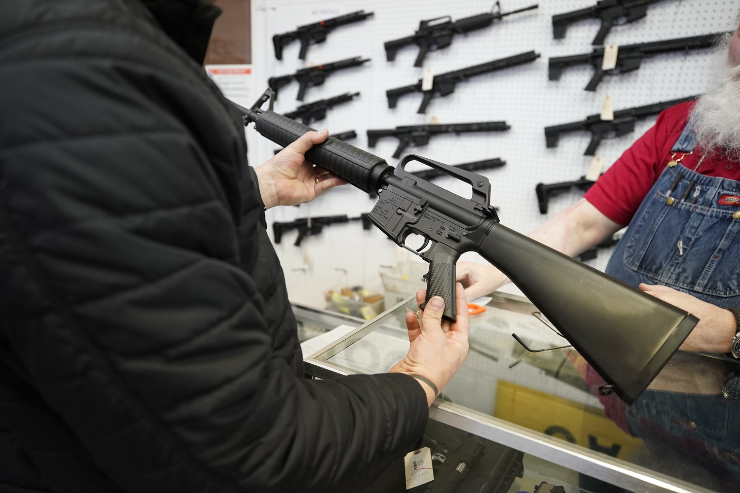 Um vendedor de armas interagindo com um cliente em uma loja.